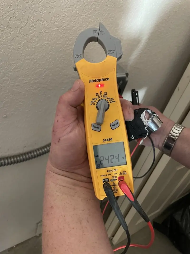 Voltage testing with clamp meter during Outlet Installation in Brown